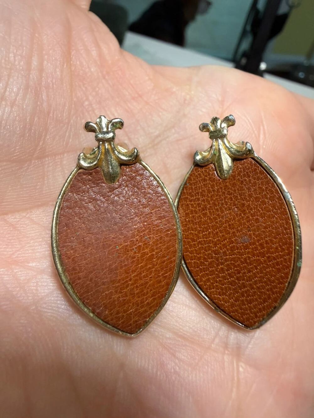 Vintage gold tone fleur de lis leather almond shaped clip on earrings